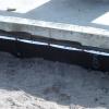 A below-grade foundation wall with a damp-proof coating
