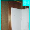 Air barrier installed behind shower stall