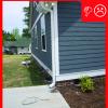 The downspout terminates too close to the foundation of the house
