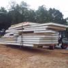 An all-terrain forklift is used to move and stage the panels