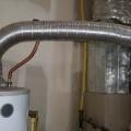 Wrong - Water heater flue pipe should be straight for a minimum of 18 inches before turning.