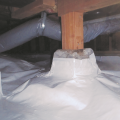 Wrong - The vapor retarder does not completely cover the pier block and is not sealed to the post; the support strapping pinches the flex duct.