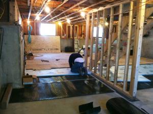 Retrofit of an existing basement slab by adding dimple plastic mat, rigid foam insulation, and a floating subfloor