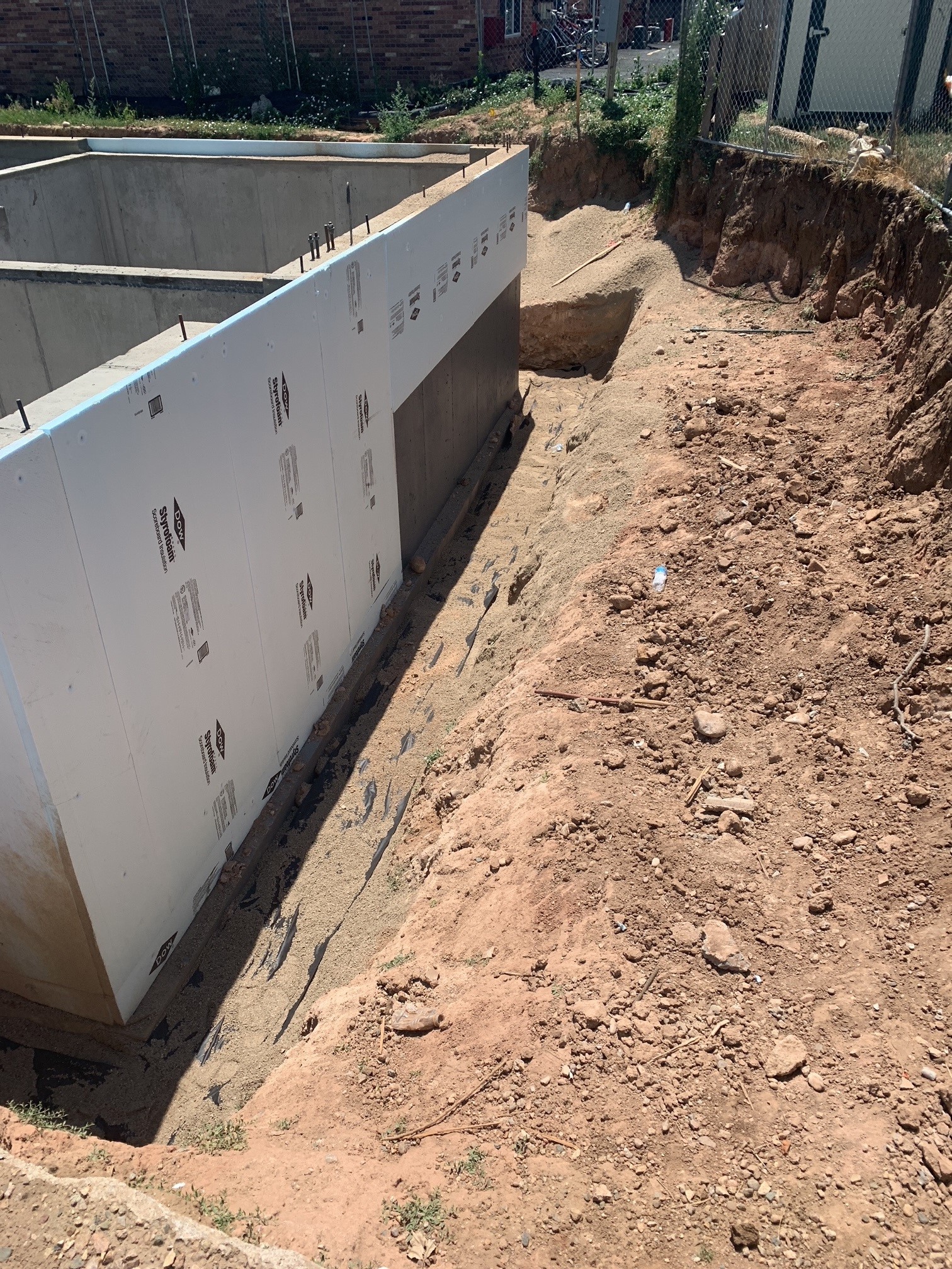 Close up on Waterproofing and insulation house foundation wall. Foundation  Waterproofing and Damp proofing Coatings. Waterproofing house foundation  with bitumen spray on tar Stock Photo