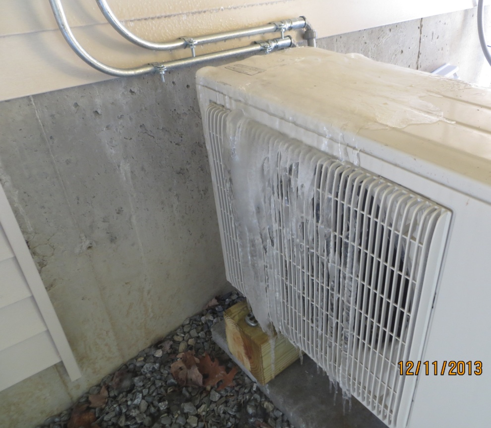 Photo of heat pump installed beneath a deck.