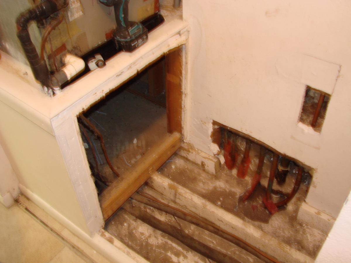 Plumbing access holes in the wall and flooring of the air handler closet allow outside air to be pulled into the air handler.
