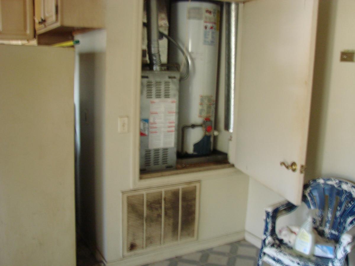 This closet is much too small to provide combustion and make-up air for the naturally aspirated gas furnace and water heater.