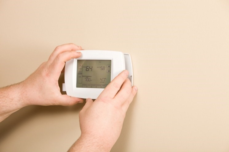 The smart thermostat should slide into the wall plate during installation.