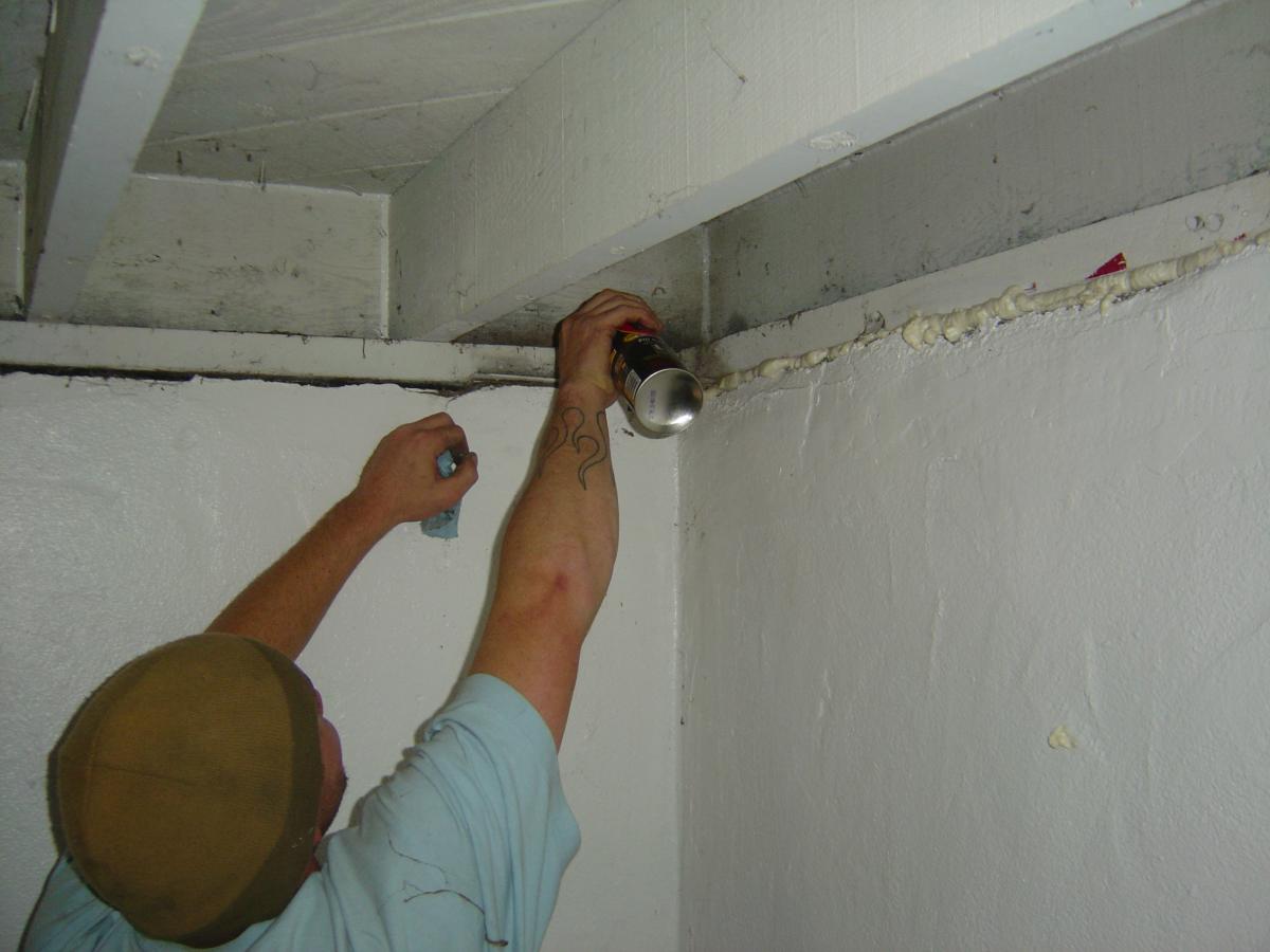 Spray foam is used to seal the seam where the sill plate sits on the foundation.