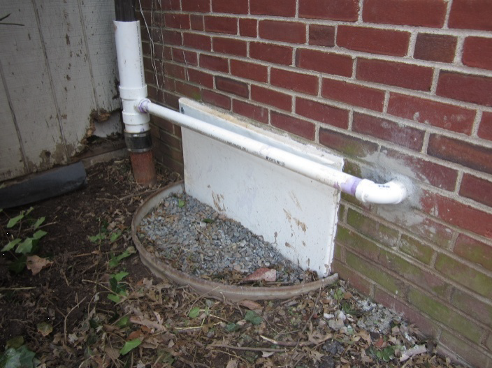 Before sealing and insulating the crawlspace, the windows were sealed, the window wells backfilled, and sumps pumps were installed that discharged to the gutter downspouts.