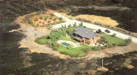 This home has defensible space around it, with a vegetation-free zone that helped the house survive a surrounding wildfire.