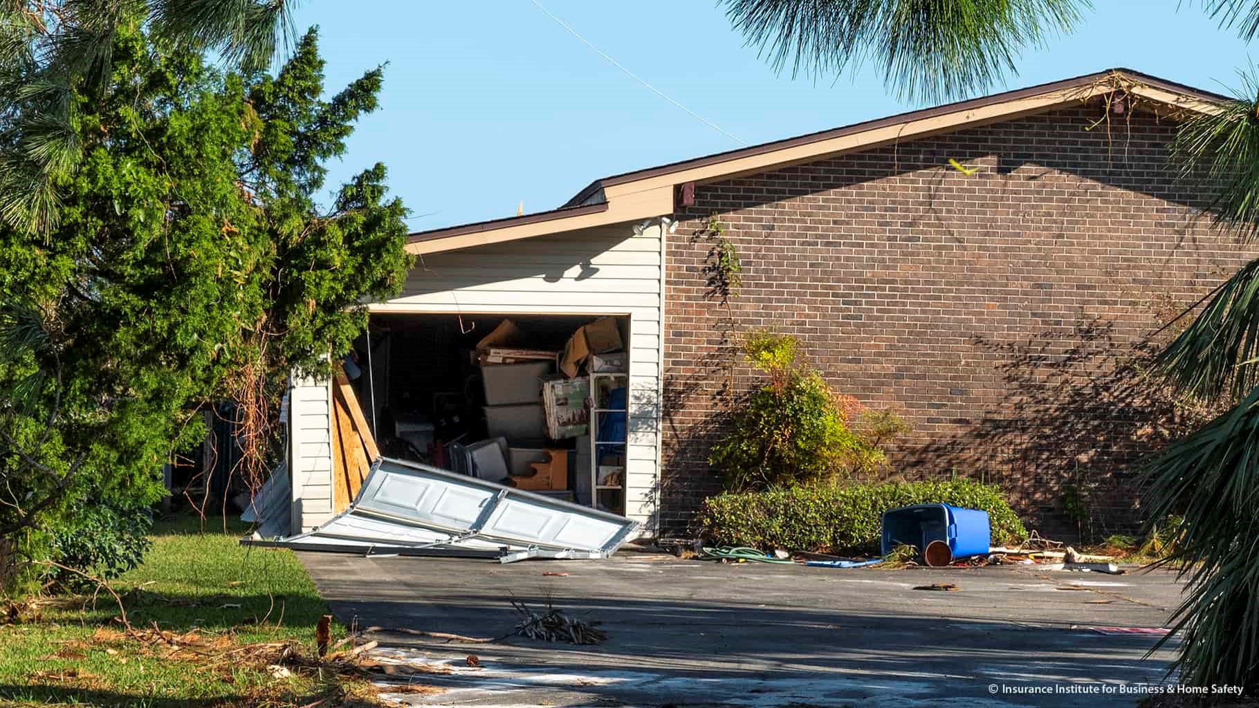 Negative pressures caused by high winds pulled this garage door out of its tracks.