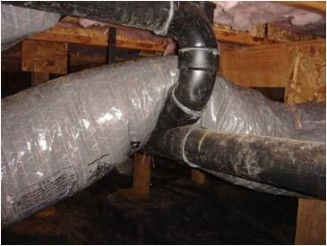 Flex duct compressed by plumbing pipes.