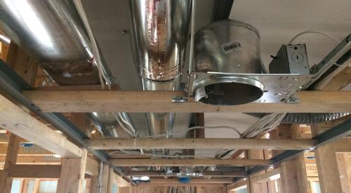 Ducts installed in the framing of a house during construction.