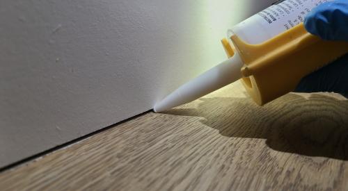 The trim-to-flooring seam can be caulked to provide an air seal at the base of the walls.