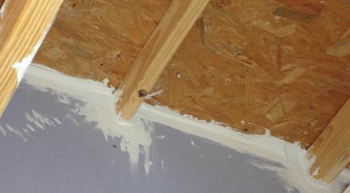 Fire-rated sealants or a fire-rated assembly air seal the tops and bottoms of the demising walls between two units in a multifamily building