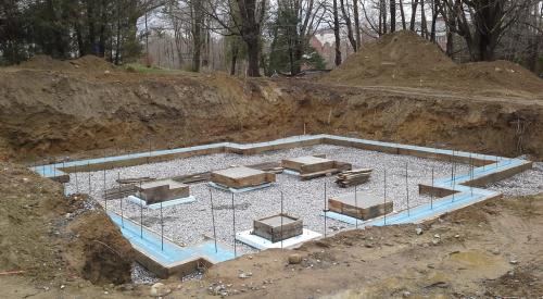The blue foam sill gasket visible on the foundation wall will help ensure an air-tight connection with the double-wall assembly above.