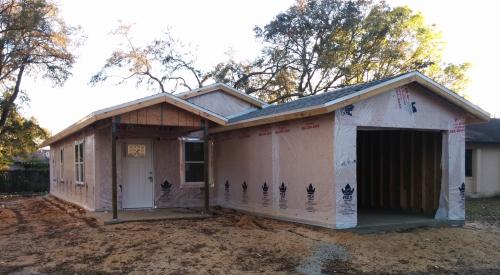 Right - Corrugated house wrap is installed over the sheathing (in this case SIPs) and overlapped and taped at all seams.