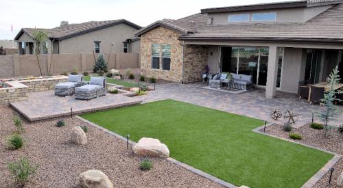 This xeriscaped yard has pavers, rock, and artificial turf.
