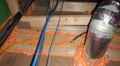 Spray foam air seals gaps around holes and drywall-to-top plate seams.