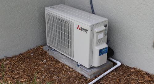 The high-efficiency mini-split heat pump provides cooling and heating; a drain pipe carries condensate away to a location that meets local code requirements.