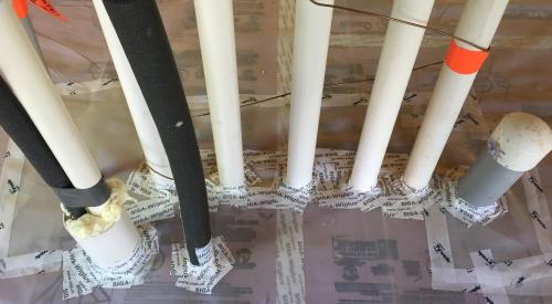 Plumbing penetrations through the below slab insulation are sealed with tape and spray foam.
