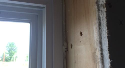 Non expanding spray foam is used to fill  the rough openings around windows.
