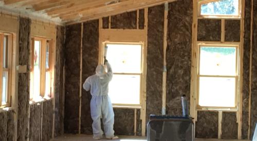 Right – Windows are being caulked after installation.