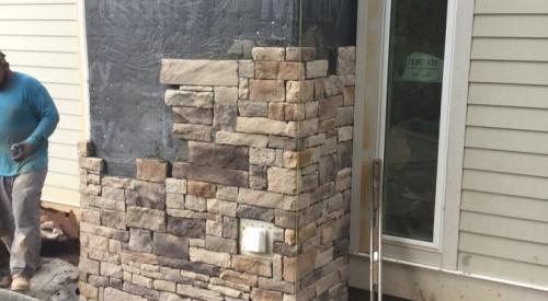Right – A rigid corrugated rain screen product is installed shingle-fashion with overlapping edges behind rock veneer.
