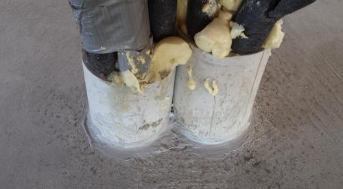 Right – Caulk seals around the pipes in the concrete.