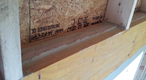 Right – A layer of sealant covers the wood-to-foam layer seams in the insulated header.
