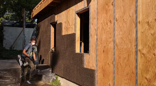 Taped plywood creates a continuous sheathing layer while cork adds a layer of continuous insulation to the outside of the wall.