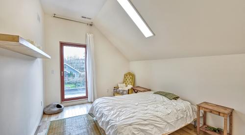 Right - Skylights provide natural light while maintaining privacy in a narrow second-story bedroom. 