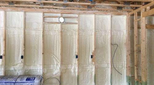 Right – the 2x6 walls are insulated with a flash-and-batt approach that includes spraying the wall cavities with one inch of open-cell foam to seal the sheathing to the framing then filling the wall cavities with R-19 fiberglass batts that are compressed slightly to fill the cavities.