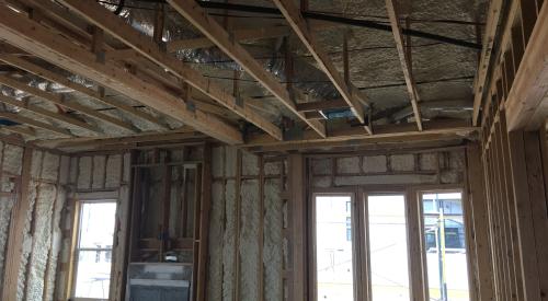 Right – Spray foam air seals and insulates the walls including the walls behind the fireplace and covers the underside of the roof deck of this mixed-dry climate home to provide an insulated attic space for HVAC ducts.