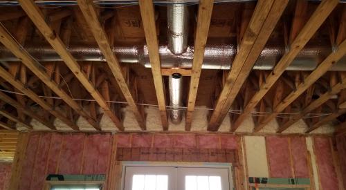Right – Fiberglass batt insulation fills the walls while the floor joists above are insulated with spray foam insulation to both insulate and air seal this transition space.