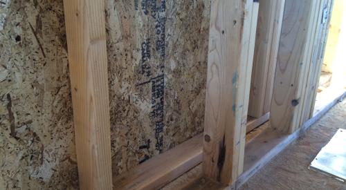 Right – This home is framed with double walls – two 2x4 walls set next to each other then sheathed with OSB on the exterior and netted on the interior face to create an extra-deep wall cavity that can be filled with blown-in insulation. 