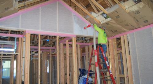Right – A strip of foam fabric is installed along the wall top plate to serve as an air sealing gasket when the drywall is installed. 