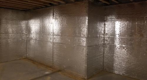 Right – The basement of this cold-climate home is insulated along interior walls with 2 inches of foil-faced rigid foam; finished basement walls also have a 2x4 interior wall insulated with R-19 blown-in fiberglass insulation and a poly vapor barrier. 