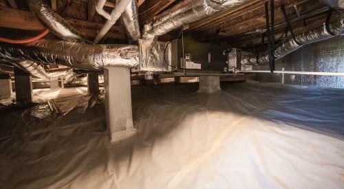 The floor of the sealed insulated crawlspace is covered with a heavy plastic vapor-barrier sheathing that is taped at all seams and around the foundation piers to prevent water vapor from moving into the crawlspace.