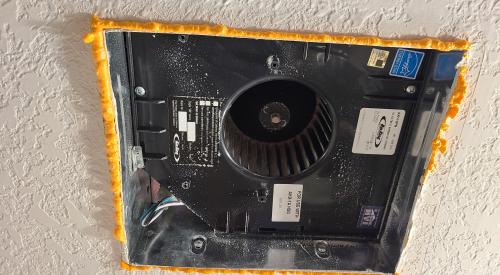 Spray foam is used to fill the small gaps around this bath fan