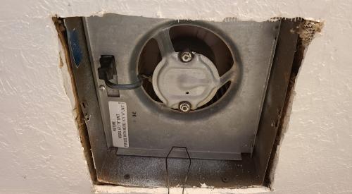 The jagged edges of the cutout around this ceiling exhaust fan require canned spray foam, metal tape, or fiberglass mesh tape and mastic to air seal the gaps and keep conditioned air from the home from escaping into the attic 