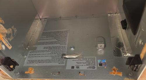 The fan was removed from this exhaust fan box to access and air seal the seams with metal tape and the holes in the housing with canned spray foam
