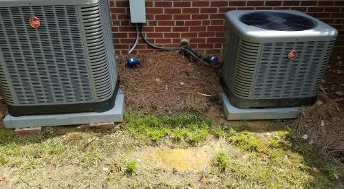 Wrong - Air conditioning compressor unit should be sitting on concrete pad installed directly on ground.