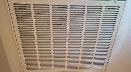 This return grille is located in a central hallway in the home and stale air is pulled through this grille and the air filter located behind it to return to the HVAC system for heating or cooling.