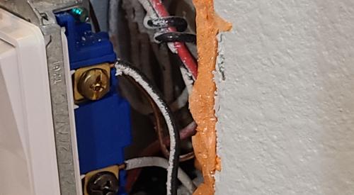 Air seal gaps between the electrical box and the drywall with caulk or low-expanding canned spray foam 