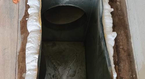 The gaps around this HVAC boot have been air sealed with spray foam to limit air leakage between the conditioned space and the basement or crawlspace.