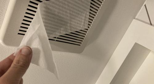 To test bathroom exhaust fan airflow, hold a tissue up to the fan while it is running; if it holds, airflow is good.