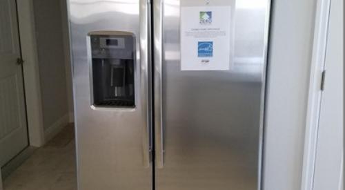 The cabinet above this refrigerator will keep it from tipping forward during a seismic event
