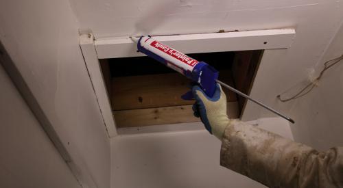 Caulk around the trim of the attic access panel or door to improve the air sealing between the living space and the attic.